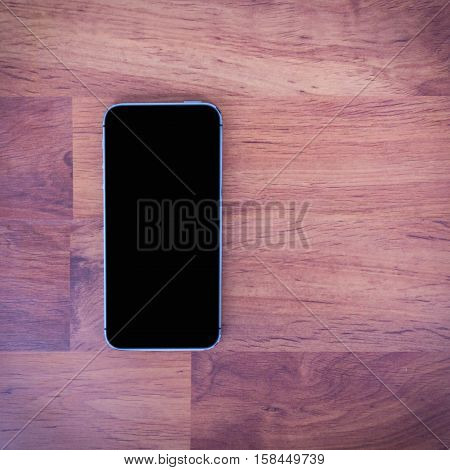 Moblie smart phone on wood table background