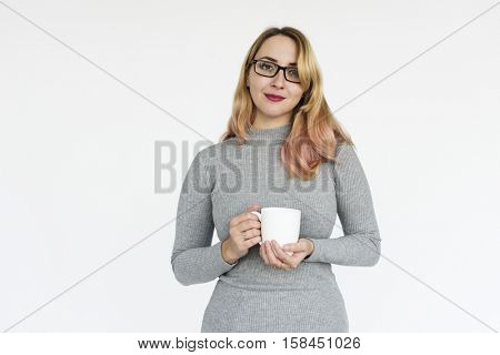 Woman in grey dress holding a cup