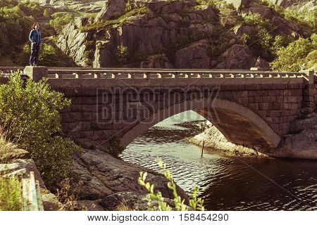 Female Tourist On Old Bridge In Norway