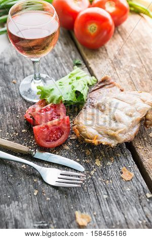 Raw beef meat.Beef steaks with vegetables and spices on a wooden floor