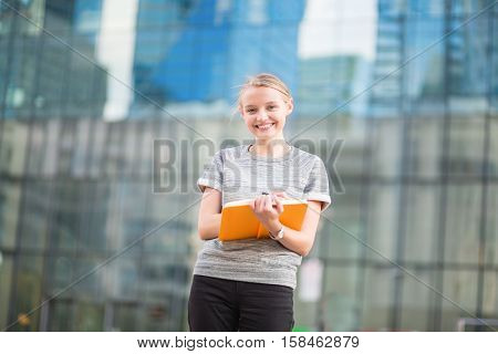 Smiling Young Woman With Notebook