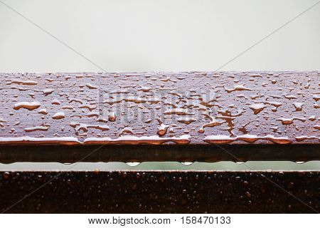 Drop of water on wood with raindrop after a rain with copy space.