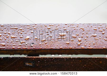 Drop of water on wood with raindrop after a rain with copy space.
