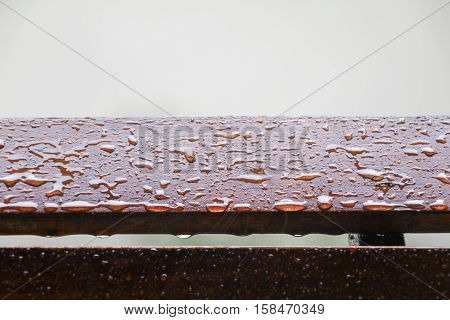 Drop of water on wood with raindrop after a rain with copy space.