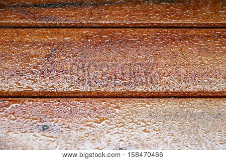 Drop of water on wood with raindrop after a rain with copy space.
