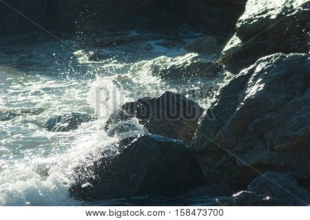 waves crashing on the sea beach rocks