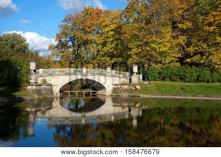 Vintage Viskontiev bridge in the autumn landscape. Pavlovsk Park. Saint-Petersburg, Russia