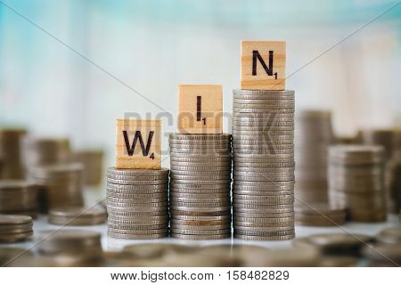 Stzck Of Coins With Wooden Scrabble Letters