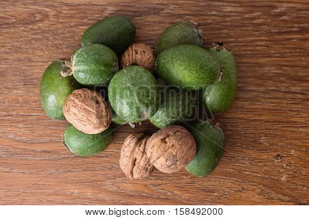 Feijoa Fruit And Walnuts On Wooden Background
