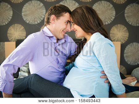 Happy young couple anticipating childs birth at home