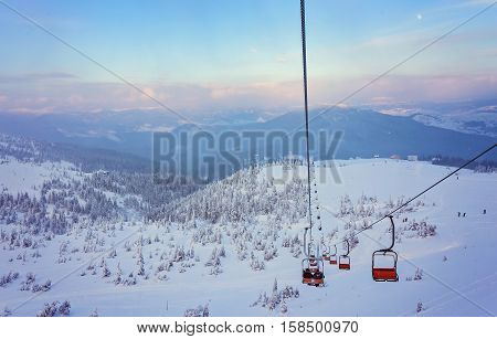 Skiers and snowboarders on a ski lift