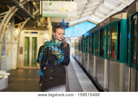 Young Woman Waiting For A Train On The Platform Of Parisian Underground