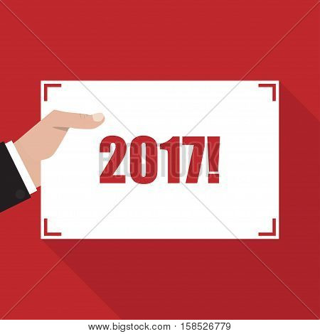 2017. Hand with sheet of paper with long shadow