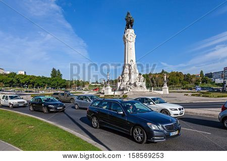 Lisbon, Portugal - October 19, 2016: Marques de Pombal Roundabout. An UBER vehicle transports a passenger, followed by a TAXI.
