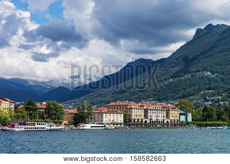 Lugano, Switzerland - August 25, 2013: Ships at the promenade of the luxurious resort in Lugano on Lake Lugano and Alps mountains in Ticino canton of Switzerland.