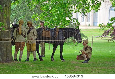 SILSOE, BEDFORDSHIRE, ENGLAND - MAY 30, 2016:  Members of the Punjab Lancers in World War One uniform looking after horses.