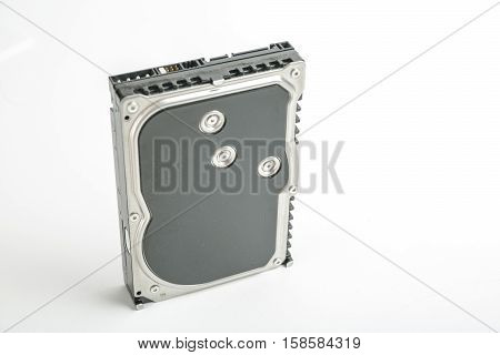 Black and silver desktop 3.5 inch hard disk. The disc has a vertical position, SATA connector upwards. Isolated on white background.