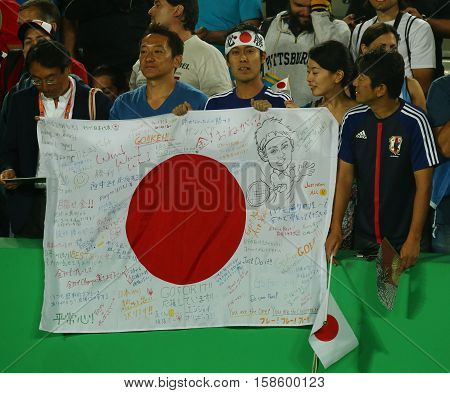 RIO DE JANEIRO, BRAZIL - AUGUST 14, 2016: Japanese fans support Kei Nishikori of Japan during men's singles tennis medal ceremony of the Rio 2016 Olympic Games