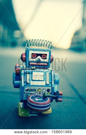 Old robot toy, vintage color style, vintage tone background.