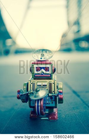 Old robot toy, vintage color style, vintage tone background.