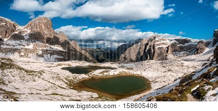Snow and mountain lake Lago dei Piani near Drei Zinnen or The cime, Italy Alps Dolomites