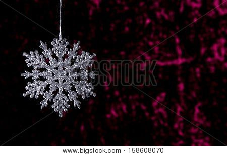 Hanging Christmas Star On A Dark Red Background