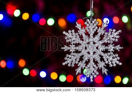 hanging Christmas star on a new year garland background