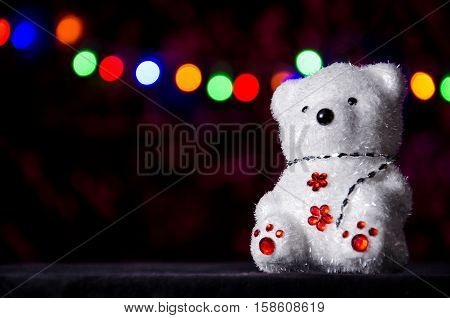 New Year's bear at the Christmas garland background