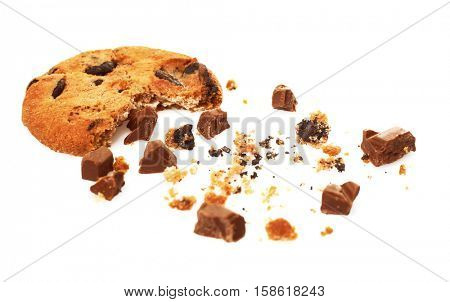 Tasty cookie with chocolate chips and crumbs on white background