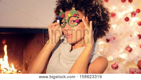 Fun vivacious young woman celebrating Christmas