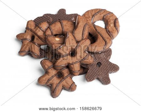 Heap of chocolate cookies in different shape isolated on white background