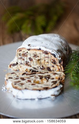 Christmas stollen. Traditional German, European festive dessert. Ingredients cranberries, pine nuts for Christmas Stollen. Stollen cake cut into pieces. Christmas food card.