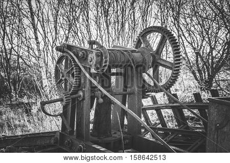 old maintenance railway machine rotting away in the woods