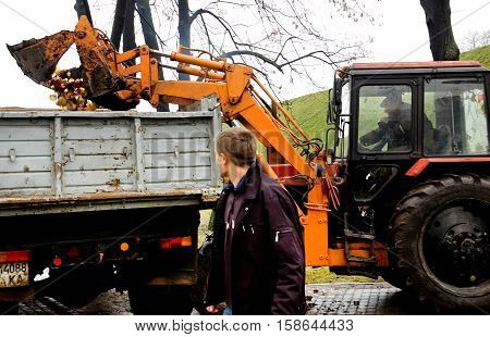 Kyiv Ukraine - December 02 2007: Tractor loading extinguished candles near the memorial to the victims of Holodomor 1932 -1933. Ukrainian nation commemorates the victims of famines (Holodomors) and political repression