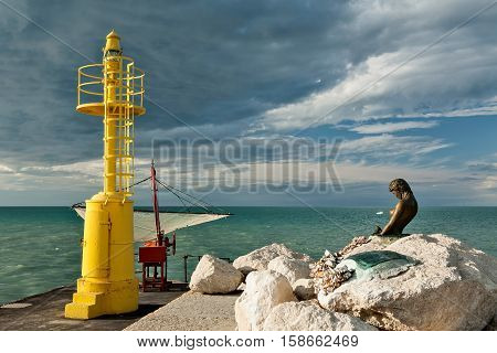 The pier in Senigallia at sunset after a storm.