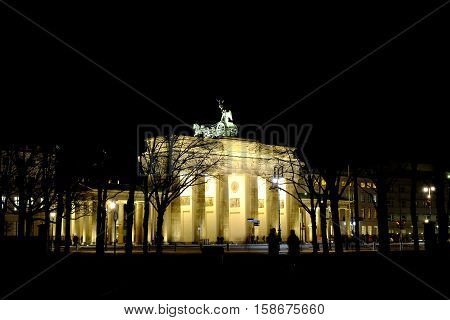 Illuminated famous Brandenburger Gate at night in Berlin, Germany.
