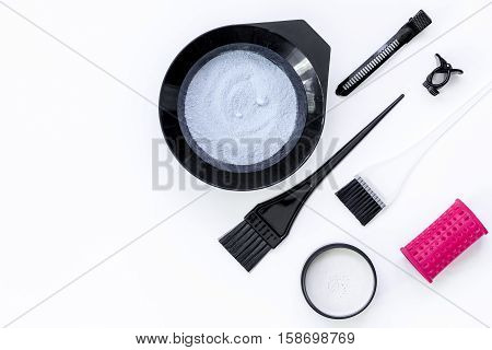 Tools for hair dye and hairdye top view on white background