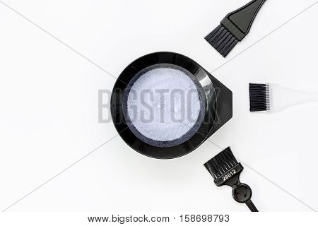 Tools for hair dye and hairdye top view on white background