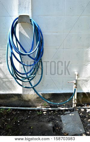 Blue hose and roll storage into the wall.