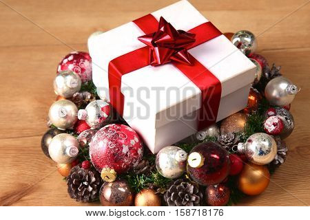 New Year gift on a golden tinsel background boly.