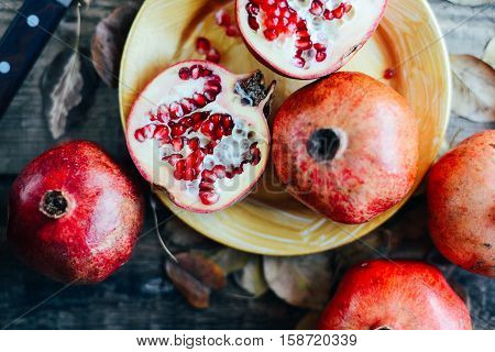 Ripe Pomegranate Fruit On Wooden Vintage Background. Red Juice P