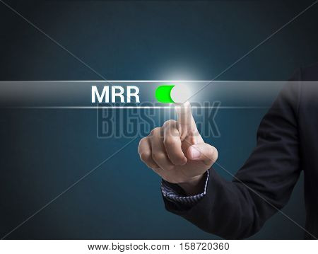 Businessman hand pressing button MRR Minimum Retail Rate. sign on virtual screen. business banking and finance concept.