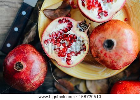 Ripe Pomegranate Fruit On Wooden Vintage Background. Red Juice P