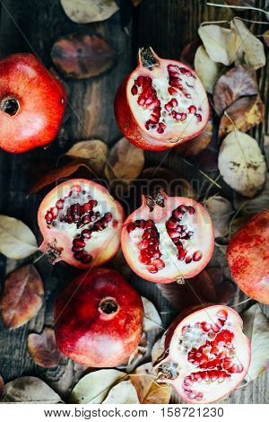 Ripe Pomegranate Fruit On Wooden Vintage Background. Red Juice P