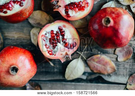 Ripe Pomegranate Fruit On Wooden Vintage Background. Red Juice P