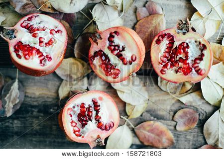 Ripe Pomegranate Fruit On Wooden Vintage Background. Red Juice P