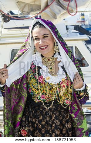 CAGLIARI, ITALY - October 29, 2016: Invitas waterfront Porto Sardinia performances of traditions and food. - Portrait of a beautiful woman in traditional Sardinian costume