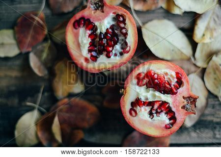 Ripe Pomegranate Fruit On Wooden Vintage Background. Red Juice P