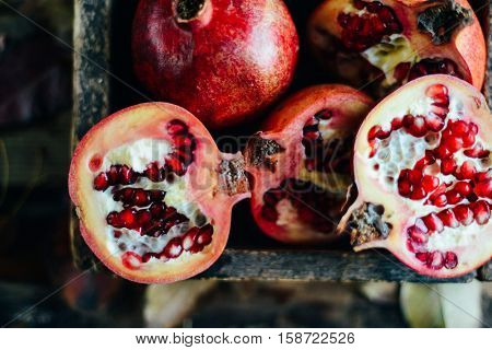 Ripe Pomegranate Fruit On Wooden Vintage Background. Red Juice P