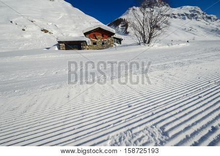 Alpine winter mountain landscape. French Alps covered with snow in sunny day. Val-d'Isere, France